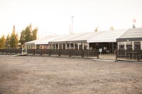 Ruokateltta rajattu mustalla puuaidalla, kuvassa myös menuteline