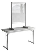Pisarasuoja S, pöytämalli (Omilla jaloillaan valkoisen seminaaripöydän päällä seisova S-koon läpinäkyvä pisarasuoja)